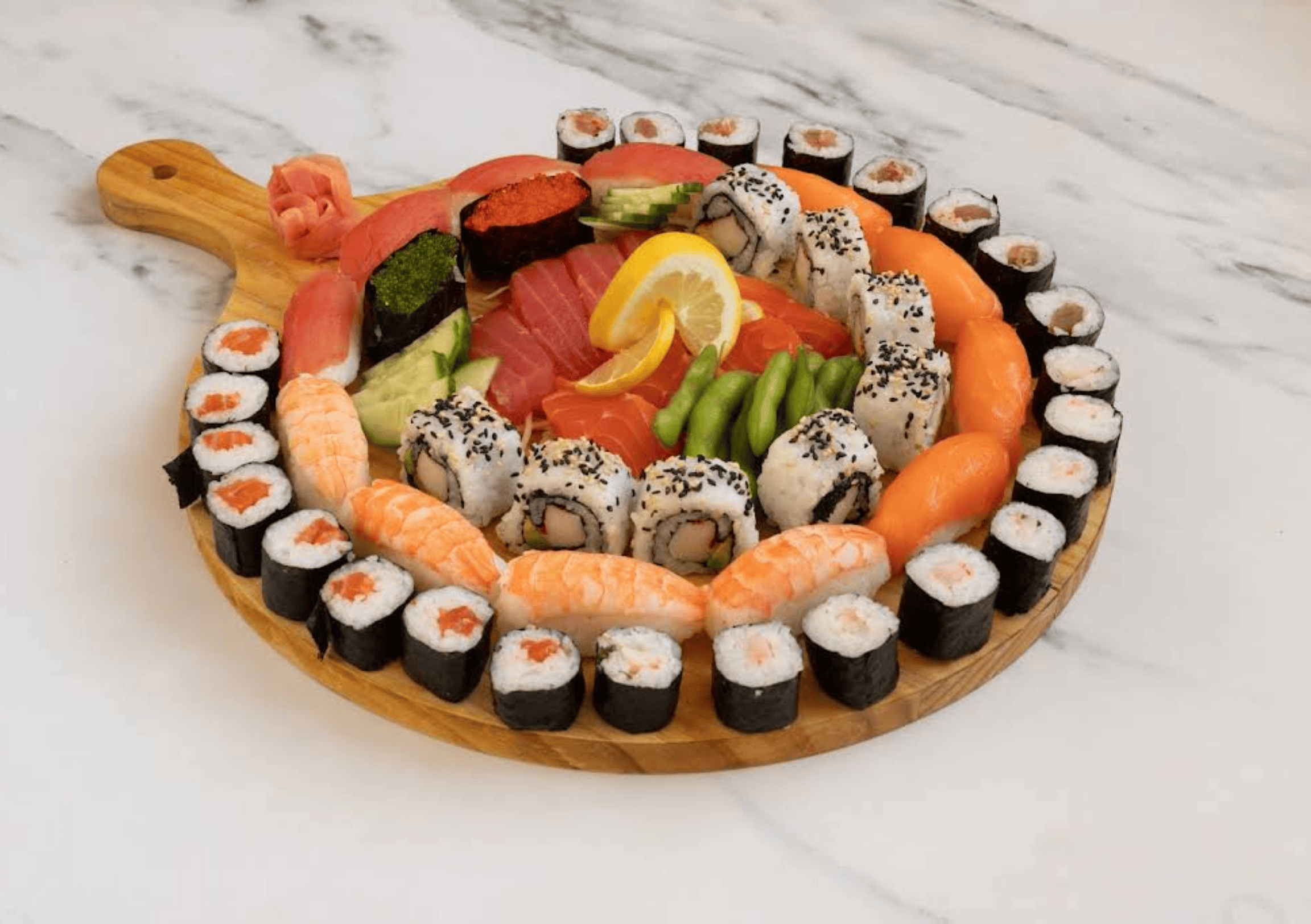 Yariika Sushi platter with nigiri, maki rolls, and sashimi, presented on a wooden board.